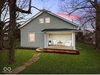 Charming house with a welcoming front porch and well-maintained lawn at 208 S Conger St, , IN 47272