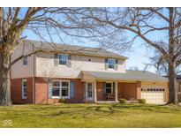 Charming two-story home with brick and siding exterior, two-car garage, and well-maintained front lawn at 2665 Chestnut St, Columbus, IN 47201