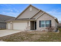 Charming single Gathering home features a three car garage, brick accents, and neutral siding, and a well-manicured lawn at 3328 Stoddard Pl, Indianapolis, IN 46217