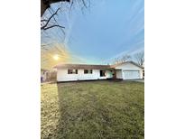 Charming one-story home featuring well-manicured lawn, attached garage, and a light blue front door at 3703 Church Dr, Anderson, IN 46013