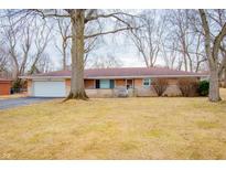 Charming single-story home with brick exterior, attached garage, and a spacious front yard with mature trees at 4503 Thornleigh Dr, Indianapolis, IN 46226