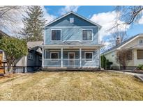 Charming two-story home featuring a welcoming front porch and classic blue siding at 5537 Broadway St, Indianapolis, IN 46220