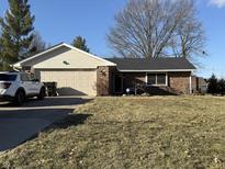 Charming brick ranch home featuring an attached two-car garage and well-manicured front lawn at 70 Joseph Ln, Whiteland, IN 46184