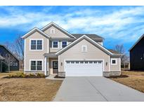 Charming two-story home featuring a two-car garage, stone accents, and a well-manicured lawn at 7168 Jackson Dr, Cumberland, IN 46229