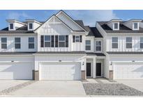 Charming townhouse featuring a clean white exterior, black shutters, and a one car garage at 7324 Shroyer Way, Noblesville, IN 46062