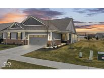 Charming home with a two-car garage and well-maintained lawn at 11758 Harvester S Cir, Noblesville, IN 46060