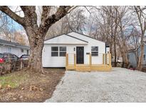 Charming renovated single-story home featuring a new wooden porch and a freshly graveled front yard at 1254 Mcdougal St, Indianapolis, IN 46203