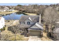 Two-story home with an attached garage, adjacent to a tranquil pond, offering a serene neighborhood setting at 15882 Arbor Grove Blvd, Noblesville, IN 46060