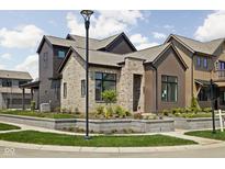 Beautiful new construction home featuring modern architecture, brick accents, and professional landscaping at 1668 Carrollton Rail Dr, Westfield, IN 46074