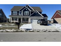 Charming two-story home featuring a two-car garage and a well-maintained front lawn on a clear winter day at 1704 Beach St, Greenwood, IN 46143