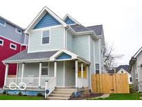 Charming two-story home with a welcoming front porch and nicely landscaped yard at 1724 Prospect St, Indianapolis, IN 46203