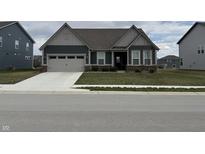 Charming single-Gathering home with a manicured lawn and attached two-car garage at 2349 S Copperstone Dr, New Palestine, IN 46163