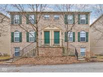 Inviting brick townhome featuring green shutters and doors at 3039 Armory Dr, Indianapolis, IN 46208