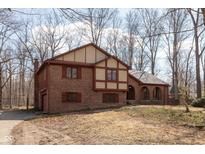 Two-story brick home featuring traditional architectural elements and a well-maintained lawn at 3810 Springfield Overlook St, Indianapolis, IN 46234