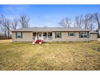 Ranch-style home featuring neutral siding, green shutters, and a welcoming front porch at 4543 E 700 N, Alexandria, IN 46001