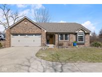 Charming brick ranch home with attached garage, manicured lawn, and inviting front entrance at 6540 Shelbyville Rd, Indianapolis, IN 46237