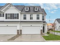 Charming new construction townhome featuring a white exterior, attached garage and landscaped front yard at 7346 Shroyer Way, Noblesville, IN 46062