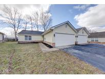 Charming home with two-car garage and well-maintained lawn in a desirable neighborhood at 7621 Orchard Village Dr, Indianapolis, IN 46217