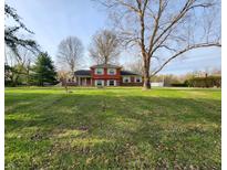 Charming two-story home with brick and siding, situated on a large lot with mature trees at 8143 Filly Ln, Plainfield, IN 46168