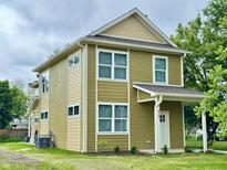 Charming two-story home featuring a clean exterior and a well-maintained lawn at 922 N Oakland Ave, Indianapolis, IN 46201