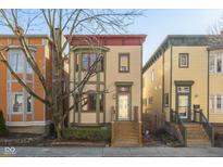Charming two-story home with a red-trimmed roof, multiple windows, and a welcoming front entrance at 925 Alabama St, Indianapolis, IN 46202