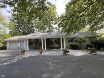 Charming one-story home with a welcoming front porch and well-manicured landscaping at 1020 W Riverview Dr, Anderson, IN 46011