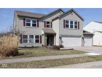 Charming two-story home with a well-maintained lawn, attached two car garage and inviting curb appeal at 10230 Tournon Dr, Fishers, IN 46037