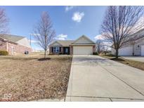 Charming single-story brick home featuring an attached garage, long driveway and well-manicured lawn at 10927 Tedder Lake Dr, Indianapolis, IN 46239