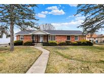 Charming brick ranch home featuring a well-manicured lawn and inviting walkway at 1157 Evans Ave, Noblesville, IN 46060