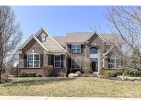 Beautiful brick home with manicured lawn, large windows, black shutters, and well-kept landscaping at 14034 Wicklow Ln, Fishers, IN 46040