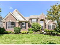 Charming brick home featuring manicured landscaping and a well-maintained lawn at 14034 Wicklow Ln, Fishers, IN 46040
