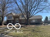Charming two-story home features a well-maintained lawn and mature trees at 15237 Citation Rd, Carmel, IN 46032