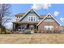 Charming two-story home with a mixed brick and siding exterior, enhanced by a covered front porch at 17136 Wetherington Dr, Westfield, IN 46074