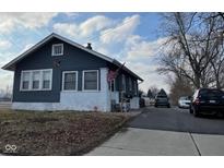 Charming home with a blue exterior, white trim, American flag, and well-maintained yard at 1913 Albany St, Beech Grove, IN 46107
