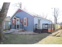 Charming blue home with wood shutters, inviting front porch, and a side deck, perfect for outdoor enjoyment at 2908 N Colorado Ave, Indianapolis, IN 46218