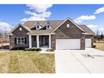 Charming brick home featuring a well-manicured lawn, dormers, and a spacious two-car garage at 3532 Danbury Ct, Bargersville, IN 46106