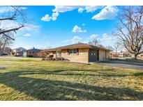 Charming single-story home with stone facade, mature trees, and a well-manicured lawn at 358 Webb Dr, Indianapolis, IN 46227