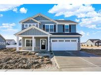 New construction two-story home with a two-car garage and stone accents, situated on a sunny day at 3667 Thomas Jefferson St, Westfield, IN 46074