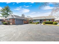 Charming single-story home features a large asphalt driveway and attached two-car garage at 5406 Allisonville Rd, Indianapolis, IN 46220
