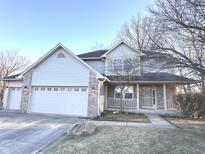 Charming two-story home with a three-car garage, a covered porch, and beautiful landscaping at 632 Middleham Cir, Beech Grove, IN 46107