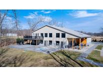 Expansive home featuring a patio, hot tub, and sleek, modern design with ample windows for natural light at 7143 W 50 S, Morgantown, IN 46160