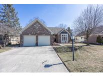 Charming brick home featuring a two-car garage and well-maintained landscaping at 7195 Koldyke Dr, Fishers, IN 46038