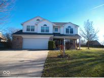 Charming two-story home with brick accents, a two-car garage, and a well-manicured front lawn at 777 West St, Whiteland, IN 46184