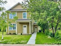 Charming two-story home with a well-manicured lawn and a welcoming walkway leading to the front door at 924 N Oakland Ave, Indianapolis, IN 46201