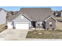Charming home featuring vinyl siding, brick accents, and a well-manicured front yard, creating a welcoming curb appeal at 936 Plunkett Ave, Westfield, IN 46074