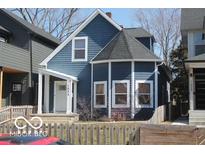 Charming two-story home with blue siding, complemented by a well-maintained front yard and inviting entrance at 1025 Dawson St, Indianapolis, IN 46203
