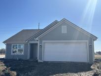 Charming single-story home with attached two-car garage, light-blue siding, and a well-maintained roof at 10265 Cliff Ln, Indianapolis, IN 46239