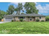 Charming single-story home with stone facade, attached garage, and well-manicured lawn at 120 E Beechwood Ln, Indianapolis, IN 46227