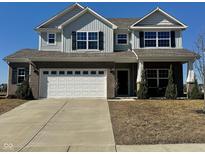 Charming two-story home featuring a two-car garage, brick accents, and a well-maintained lawn at 18228 Nickel Plate Dr, Westfield, IN 46074