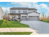 Charming two-story home with a well-manicured lawn and a welcoming front porch at 19477 Quilling Ln, Noblesville, IN 46062